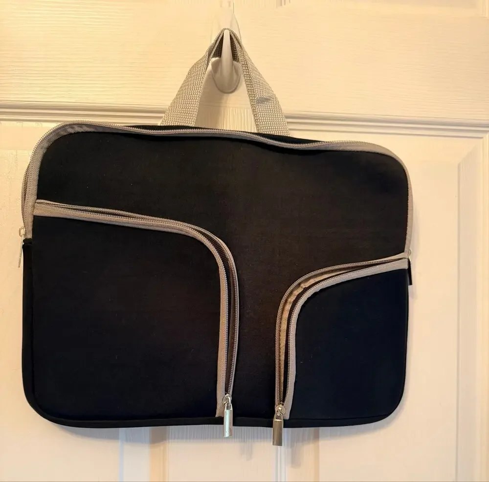 Black laptop sleeve bag features gray zipper compartment carrying handle.